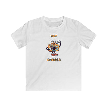 White kids t-shirt with a cartoon camera and text say cheese kids tee by Printify