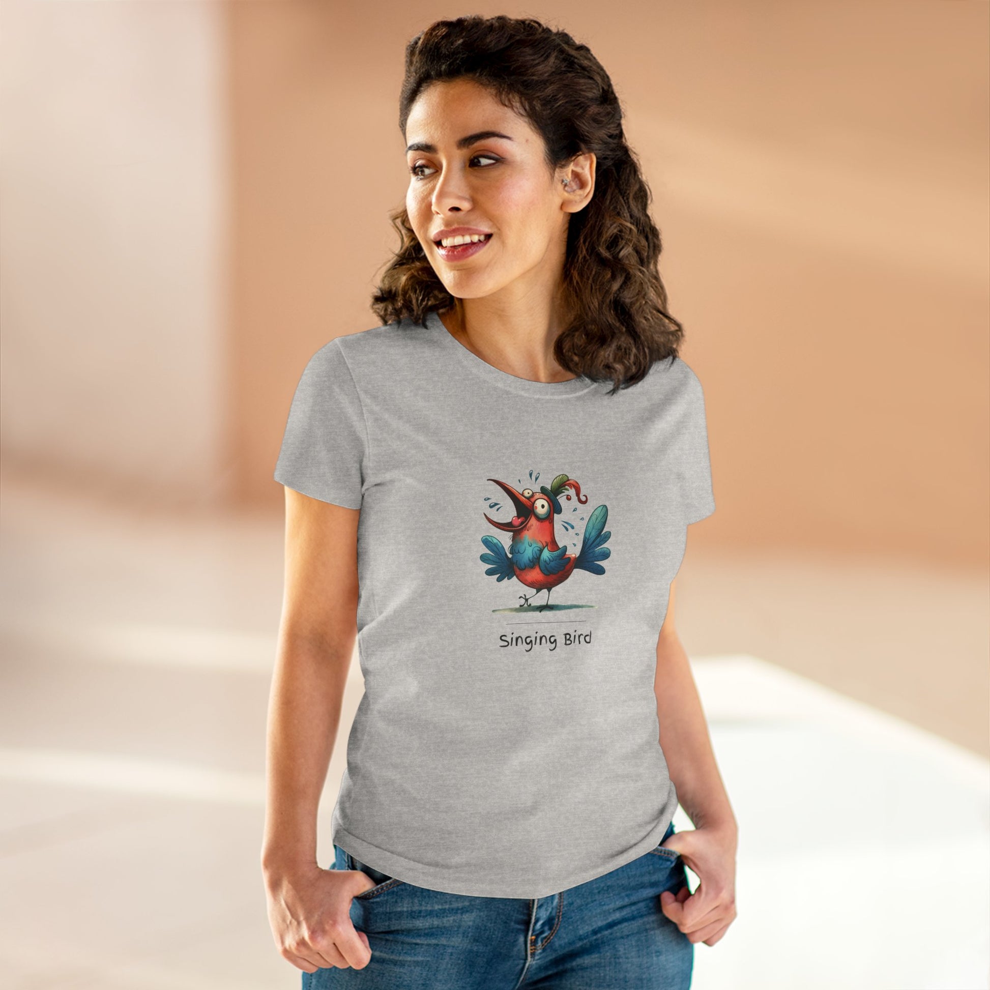 Gray Printify t-shirt featuring colorful cartoon singing bird shirt design worn by smiling woman