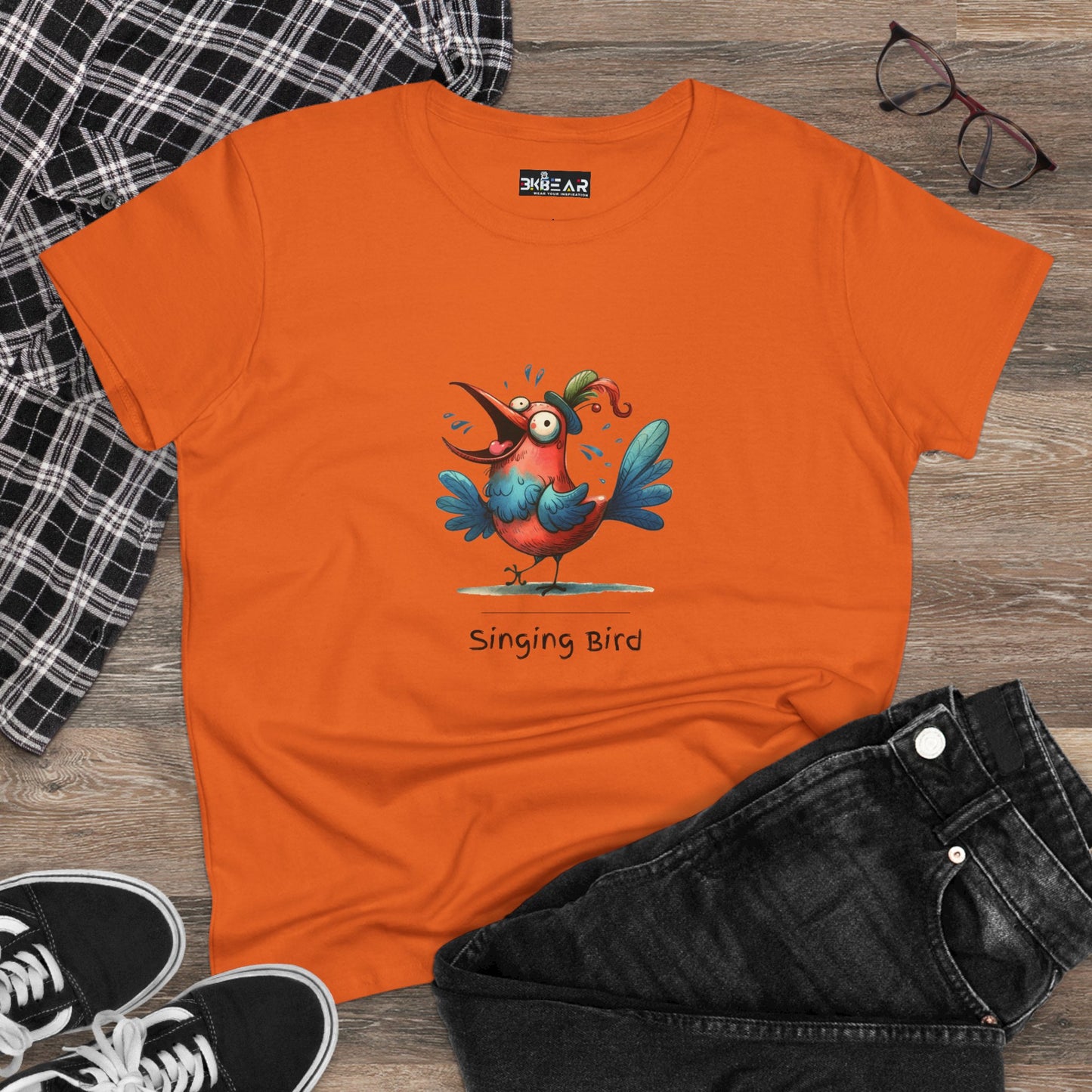 Orange singing bird shirt with a colorful cartoon bird graphic on the front by Printify