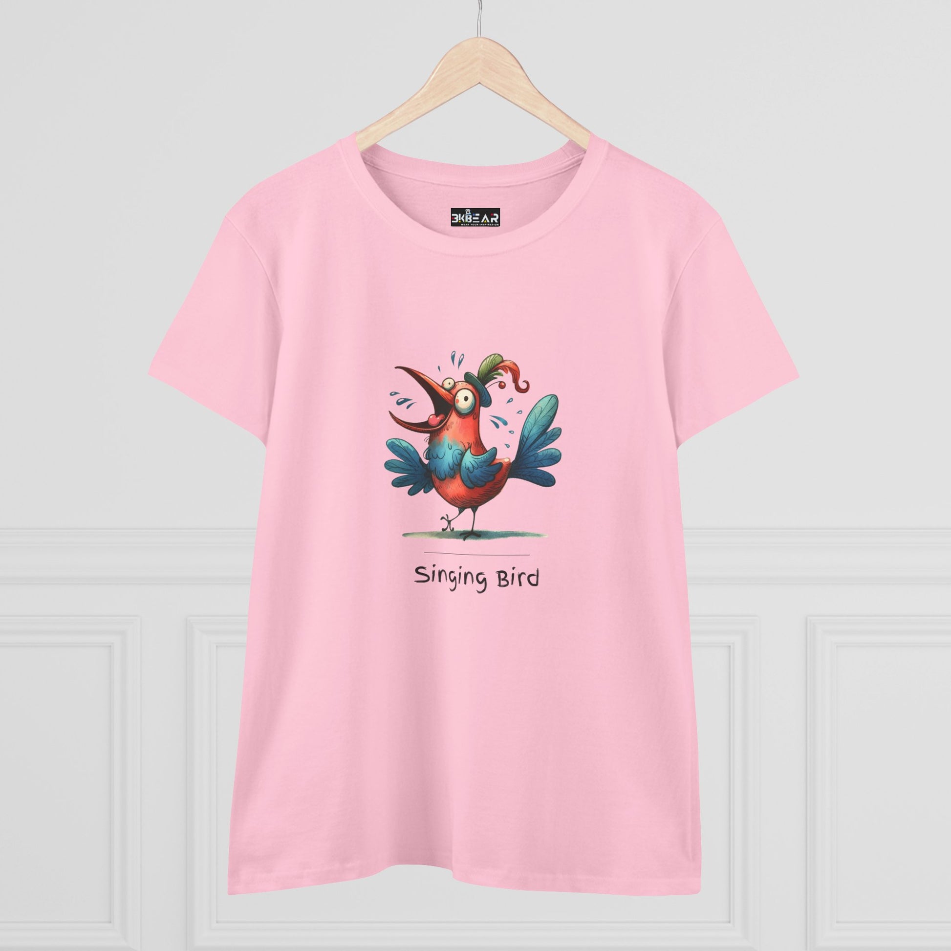 Pink Printify t-shirt with colorful cartoon singing bird graphic and text singing bird shirt