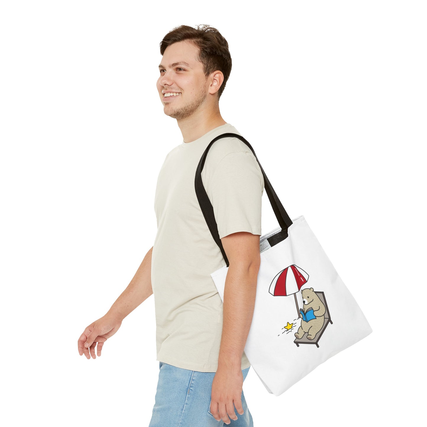Man carrying a summer beach tote with bear design featuring a bear lounging under an umbrella