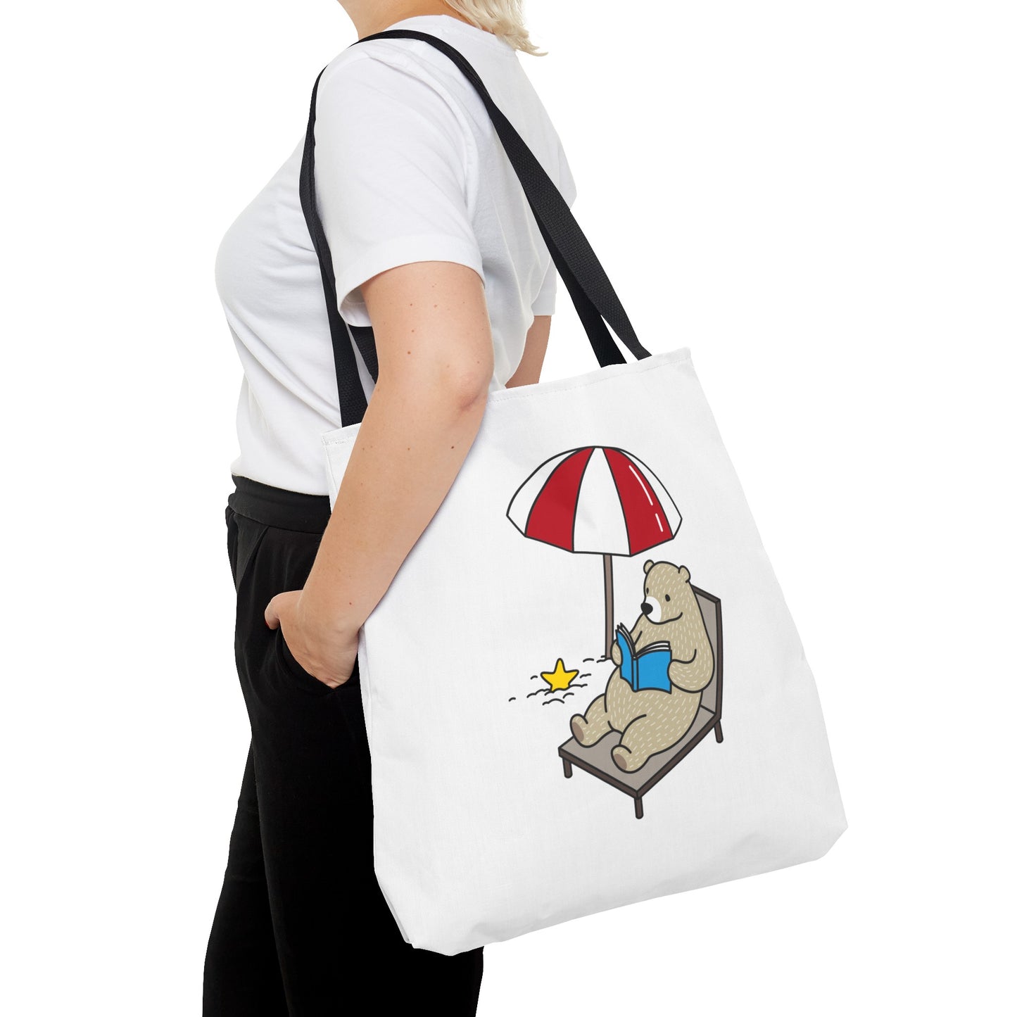 Summer beach tote with bear design carried by woman wearing white shirt and black pants