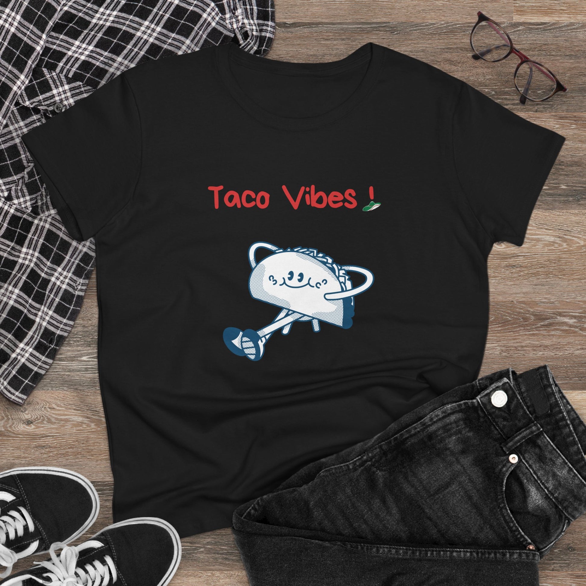 Black taco graphic tee with cartoon taco and Taco Vibes text by Printify laid out with jeans and sneakers
