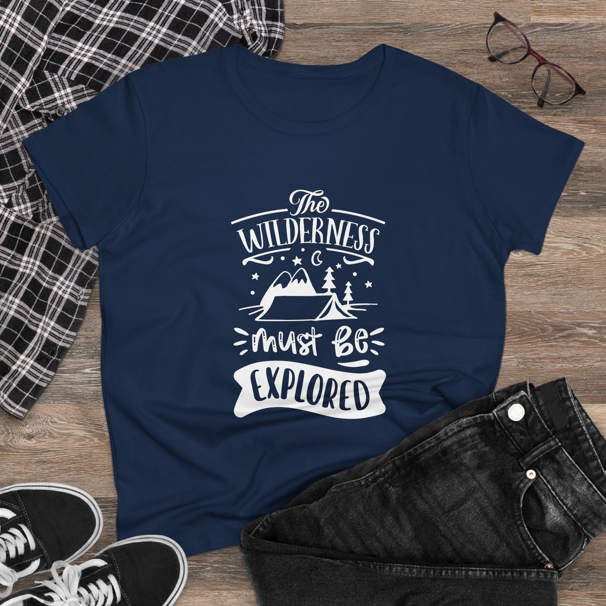 Navy printify wilderness exploration shirt with white outdoor design, displayed with casual clothing and glasses